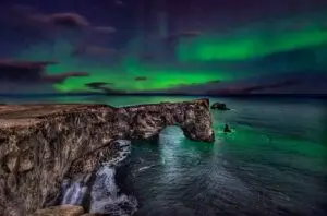 Northern lights above Dyrhólaey Rock Arch, Iceland