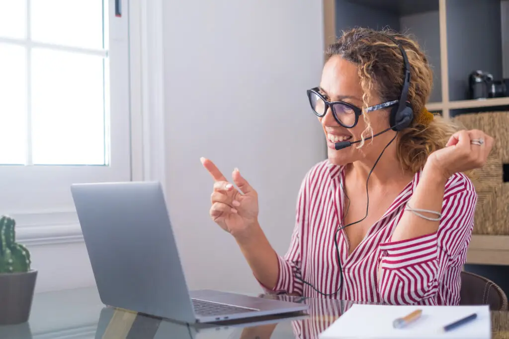 Attractive caucasian woman working as a virtual tour guide for Icelandic Private Tours, engaging with clients from her home office