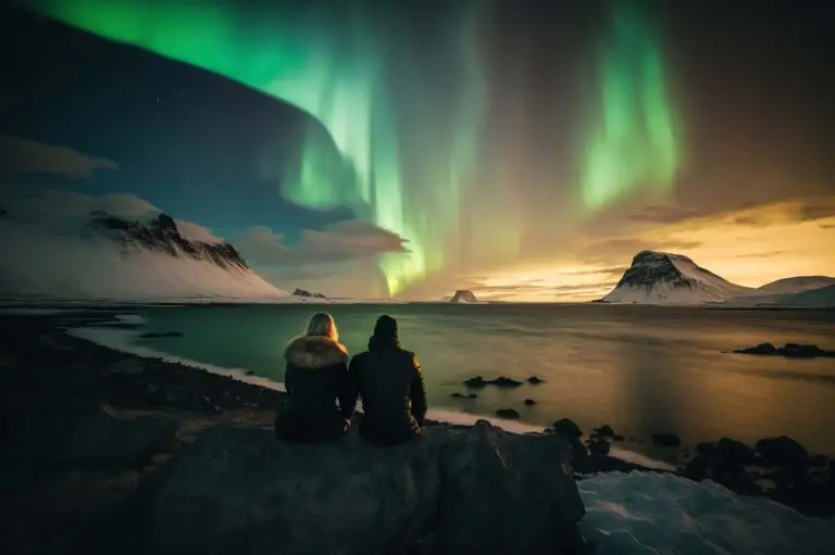 Couple enjoying a stunning Northern Lights display over a snow-covered Icelandic landscape, ideal for custom private tours in Iceland.