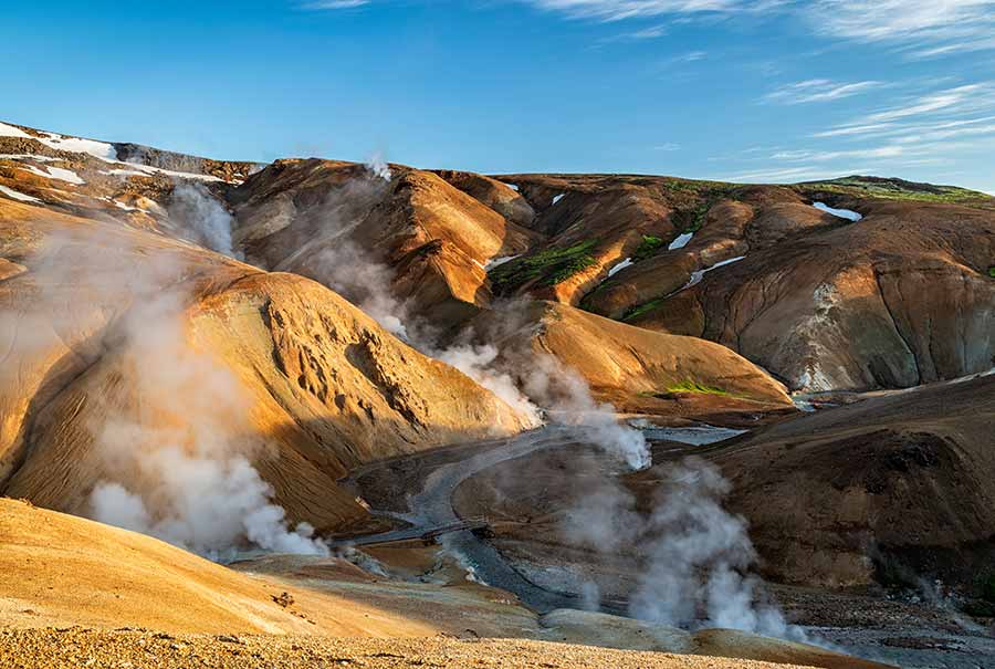 Scenic view of the steamy, colorful terrain of Kerlingarfjoll Geothermal Area in Iceland, showcasing sulfur deposits and hot springs.